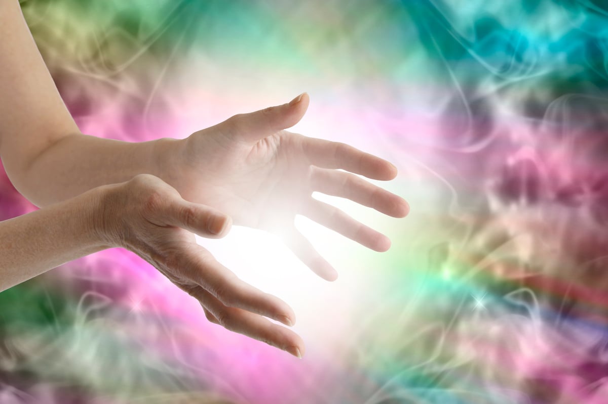 Healing hands with glowing energy between them